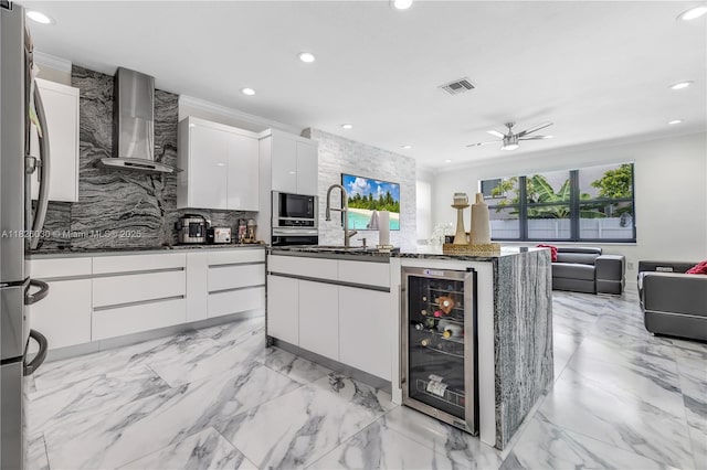 16488 SW 30th St, Miramar, FL 33027 - kitchen featuring wall chimney range hood, wine cooler, modern cabinets, tasteful backsplash, and recessed lighting