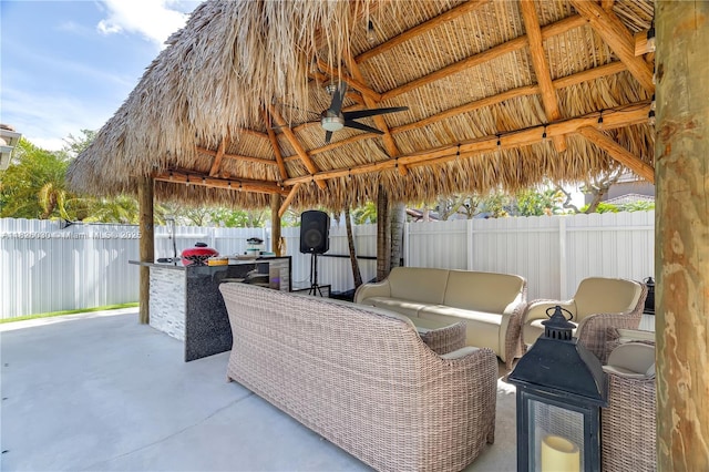 16488 SW 30th St, Miramar, FL 33027 - fenced backyard with a gazebo, an outdoor kitchen, a patio, a ceiling fan, and an outdoor living space