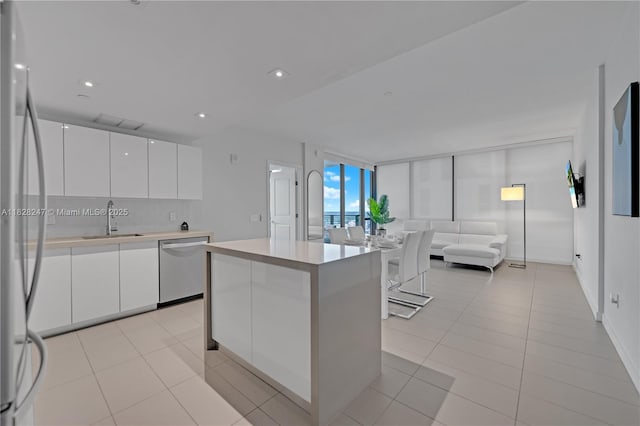 1600 NE 1st Ave Unit 2916, Miami, FL 33132 - kitchen featuring dishwasher, freestanding refrigerator, white cabinets, open floor plan, and modern cabinets
