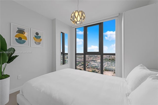 1600 NE 1st Ave Unit 2916, Miami, FL 33132 - bedroom featuring multiple windows, a chandelier, and carpet flooring