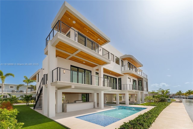 301 Buttonwood Cir # A, Key Largo, FL 33037 - back of house featuring a balcony, stucco siding, and stairs