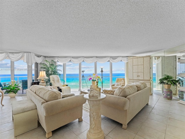 16445 Collins Ave Unit 726, Sunny Isles Beach, FL 33160 - living area featuring a textured ceiling, a water view, and light tile patterned floors