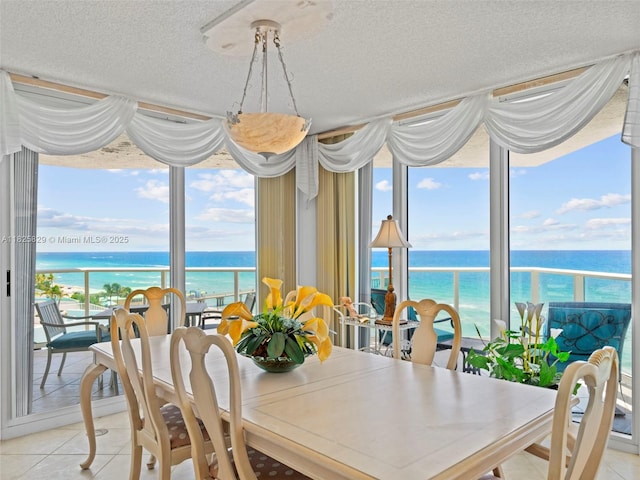 16445 Collins Ave Unit 726, Sunny Isles Beach, FL 33160 - dining room with a water view, light tile patterned floors, and a textured ceiling