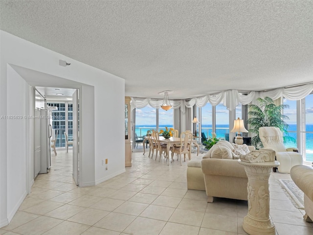 16445 Collins Ave Unit 726, Sunny Isles Beach, FL 33160 - living area featuring light tile patterned floors, a textured ceiling, and a water view