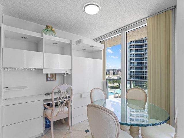 16445 Collins Ave Unit 726, Sunny Isles Beach, FL 33160 - dining space featuring built in study area, light tile patterned floors, a textured ceiling, and floor to ceiling windows