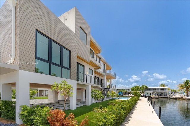301 Buttonwood Cir # B, Key Largo, FL 33037 - dock with a water view, a patio, and stairway