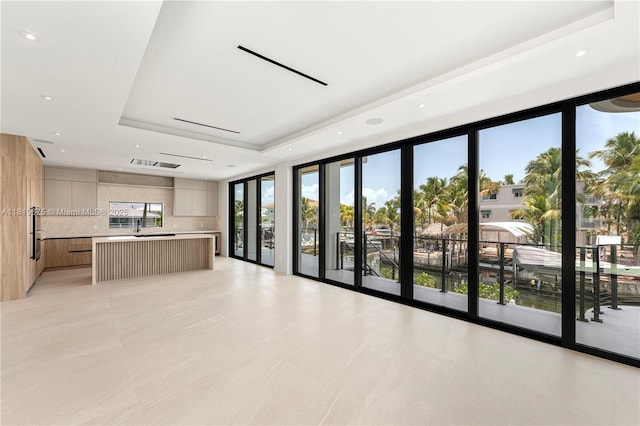 301 Buttonwood Cir # B, Key Largo, FL 33037 - unfurnished living room with a tray ceiling and light tile patterned floors