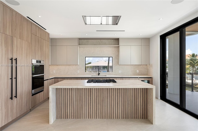 301 Buttonwood Cir # B, Key Largo, FL 33037 - kitchen featuring modern cabinets, a center island, appliances with stainless steel finishes, and backsplash