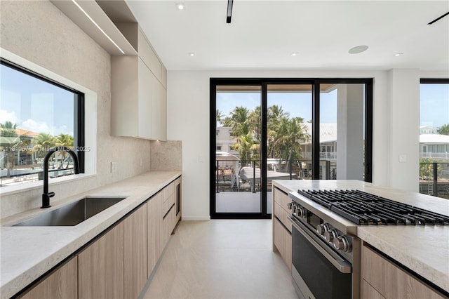 301 Buttonwood Cir # B, Key Largo, FL 33037 - kitchen with stainless steel range, modern cabinets, light brown cabinets, and light stone countertops