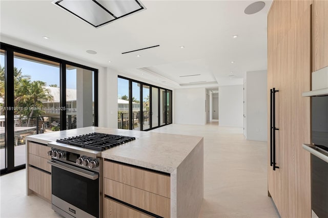 301 Buttonwood Cir # B, Key Largo, FL 33037 - kitchen featuring light brown cabinetry, modern cabinets, appliances with stainless steel finishes, open floor plan, and a kitchen island