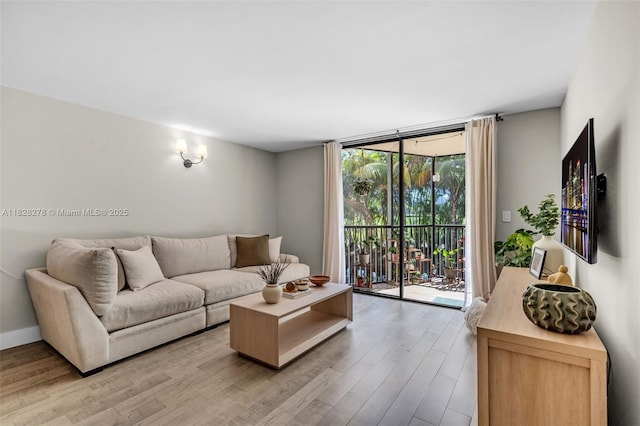 20367 W Country Club Dr Unit L25, Aventura, FL 33180 - living area with light wood-type flooring and a wall of windows