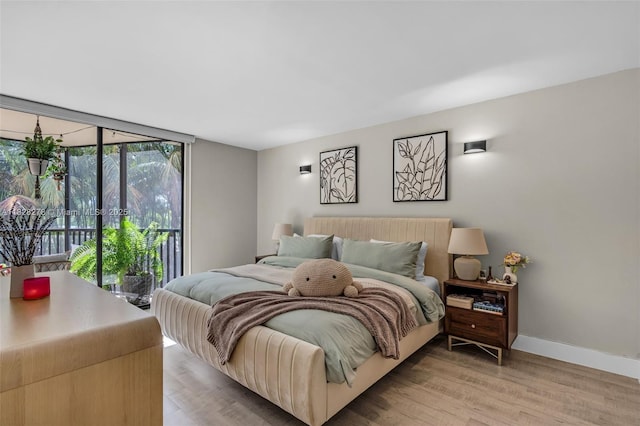 20367 W Country Club Dr Unit L25, Aventura, FL 33180 - bedroom featuring access to outside, light wood-style flooring, and a wall of windows