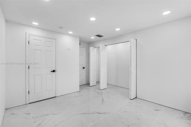 770 SE 5th Pl, Hialeah, FL 33010 - unfurnished bedroom with recessed lighting, light marble finish floors, and multiple closets
