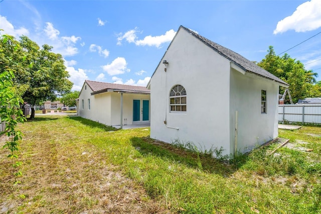 770 SE 5th Pl, Hialeah, FL 33010 - view of home's exterior featuring french doors and stucco siding