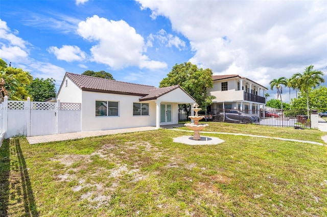 770 SE 5th Pl, Hialeah, FL 33010 - rear view of property with a tile roof, french doors, a fenced backyard, stucco siding, and a gate