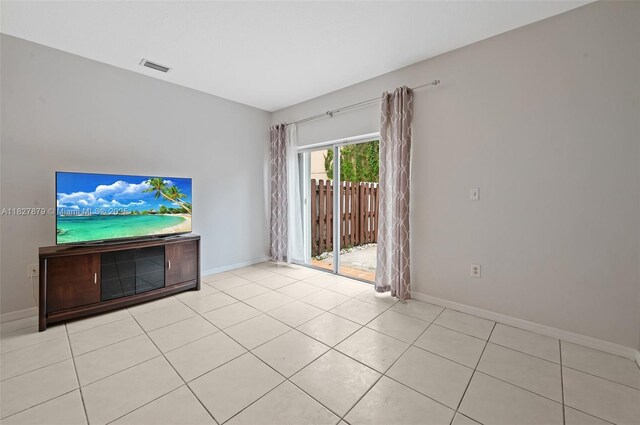 8366 NW 10th St Unit 3B, Miami, FL 33126 - unfurnished living room with baseboards and light tile patterned flooring