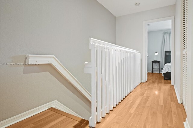 8366 NW 10th St Unit 3B, Miami, FL 33126 - corridor featuring light wood-style floors, radiator heating unit, and an upstairs landing