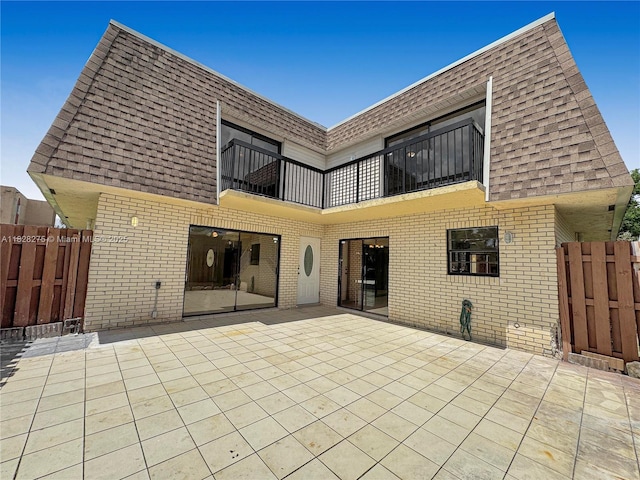 8103 SW 24th St, North Lauderdale, FL 33068 - back of property with a balcony, brick siding, a patio, and roof with shingles