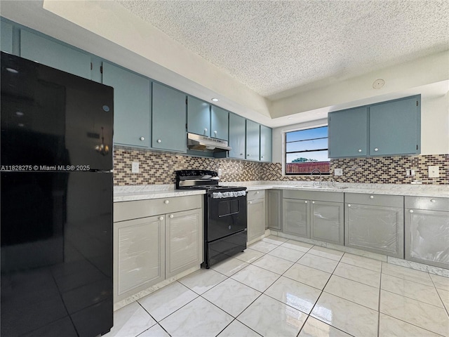 8103 SW 24th St, North Lauderdale, FL 33068 - kitchen featuring black appliances, under cabinet range hood, a textured ceiling, light countertops, and backsplash