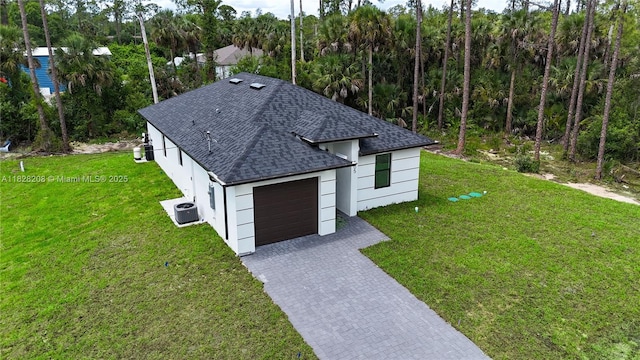 505 W 10th St, Lehigh Acres, FL 33972 - view of front of house with a shingled roof, a garage, a front yard, and decorative driveway