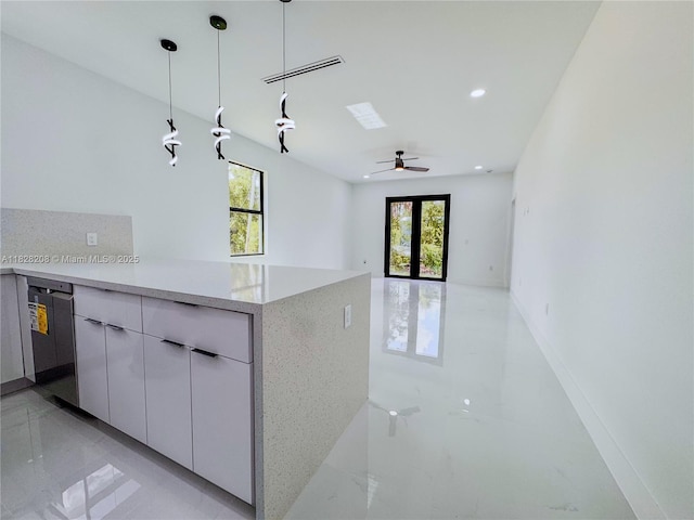 505 W 10th St, Lehigh Acres, FL 33972 - kitchen featuring hanging light fixtures, a ceiling fan, modern cabinets, light stone countertops, and a peninsula
