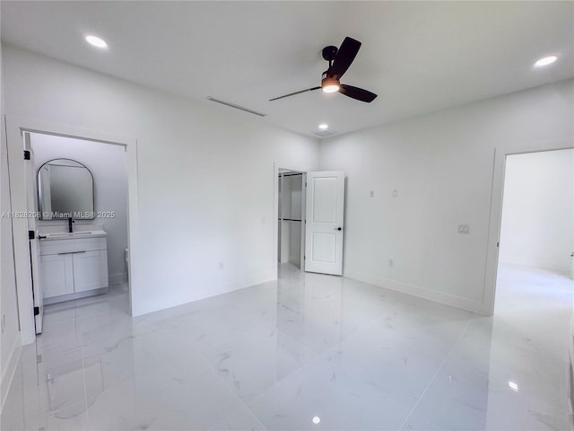 505 W 10th St, Lehigh Acres, FL 33972 - unfurnished bedroom featuring light marble finish floors, connected bathroom, recessed lighting, and a ceiling fan
