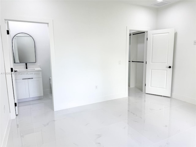 505 W 10th St, Lehigh Acres, FL 33972 - spare room featuring a sink and light marble finish flooring