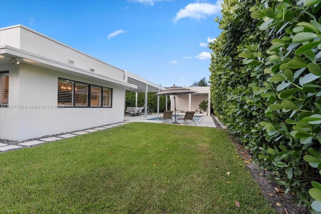 2180 Alamanda Dr, North Miami, FL 33181 - view of grassy yard with an outdoor living space and a patio area