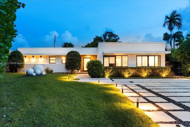 2180 Alamanda Dr, North Miami, FL 33181 - view of front of house featuring a front lawn and stucco siding