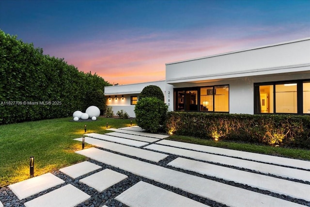 2180 Alamanda Dr, North Miami, FL 33181 - view of front of property with stucco siding and a lawn