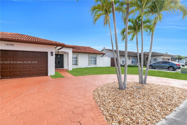 14795 SW 174th St, Miami, FL 33187 - view of front of property featuring decorative driveway, stucco siding, an attached garage, and a front yard