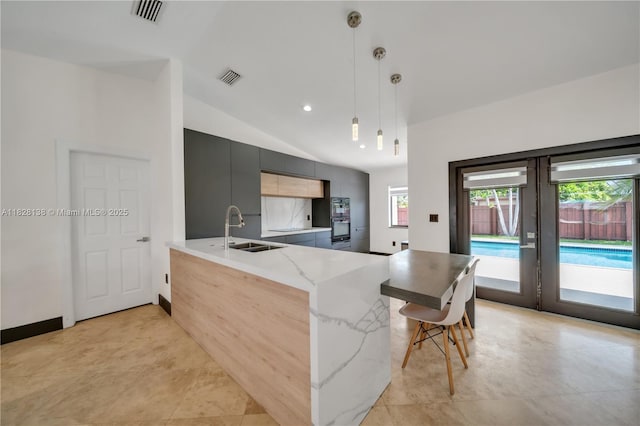 14795 SW 174th St, Miami, FL 33187 - kitchen featuring modern cabinets, a peninsula, decorative light fixtures, french doors, and light stone countertops