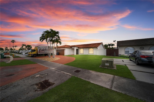 14795 SW 174th St, Miami, FL 33187 - ranch-style house featuring a lawn, driveway, an attached garage, and stucco siding