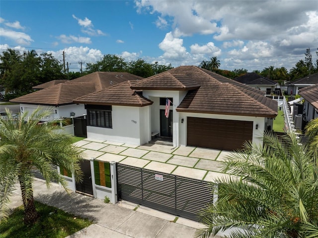 1550 SW 89th Ct, Miami, FL 33174 - view of front of house with stucco siding, a tiled roof, an attached garage, and driveway
