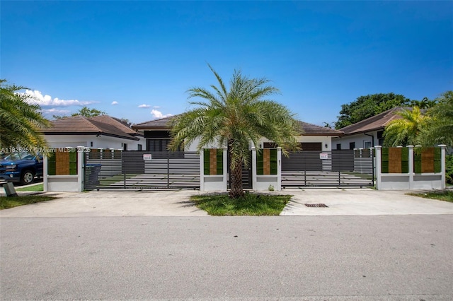 1550 SW 89th Ct, Miami, FL 33174 - view of front facade featuring a gate, a fenced front yard, and stucco siding