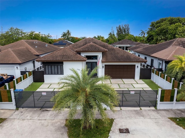 1550 SW 89th Ct, Miami, FL 33174 - view of front facade with stucco siding, a fenced front yard, an attached garage, and a tile roof