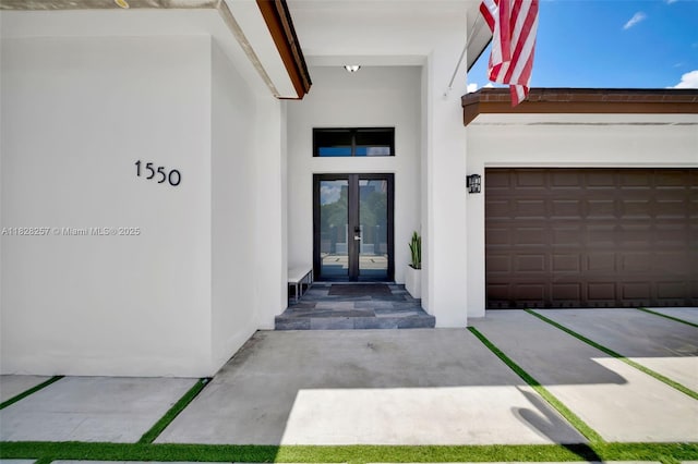 1550 SW 89th Ct, Miami, FL 33174 - entrance to property with french doors, stucco siding, and a garage