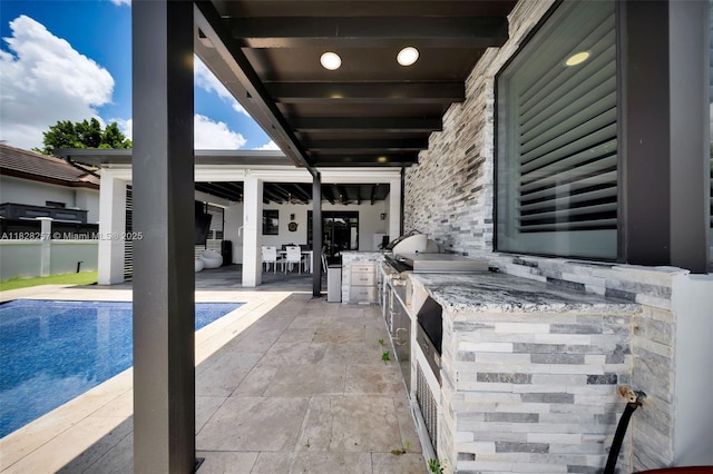 1550 SW 89th Ct, Miami, FL 33174 - view of patio with exterior kitchen and an outdoor pool