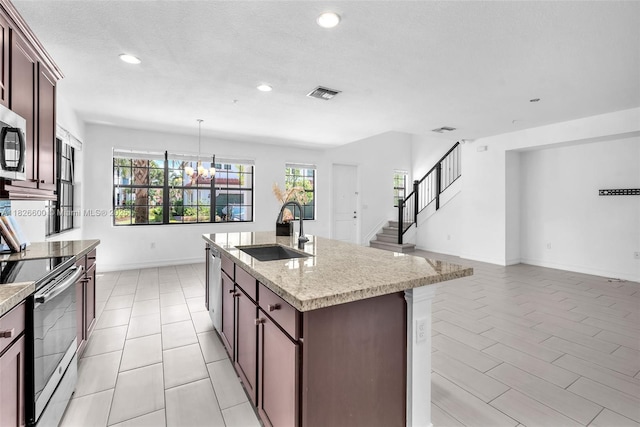 11735 SW 13th Ct, Pembroke Pines, FL 33025 - kitchen featuring appliances with stainless steel finishes, recessed lighting, an island with sink, a chandelier, and decorative light fixtures