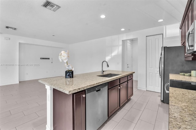 11735 SW 13th Ct, Pembroke Pines, FL 33025 - kitchen featuring stainless steel appliances, a kitchen island with sink, recessed lighting, dark brown cabinetry, and light stone counters