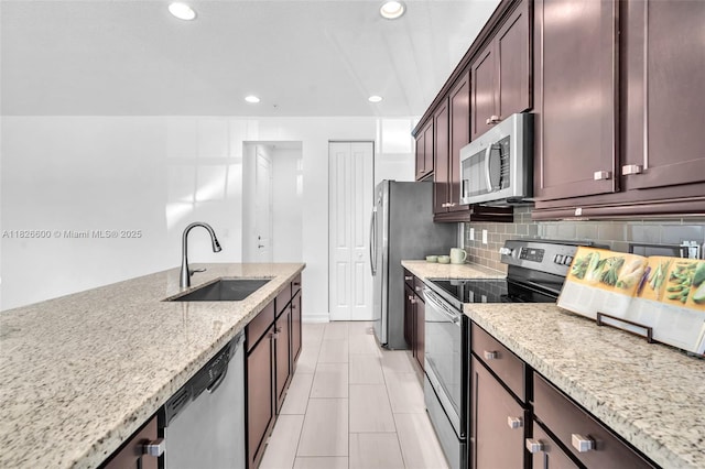 11735 SW 13th Ct, Pembroke Pines, FL 33025 - kitchen with stainless steel appliances, recessed lighting, tasteful backsplash, light stone countertops, and dark brown cabinetry