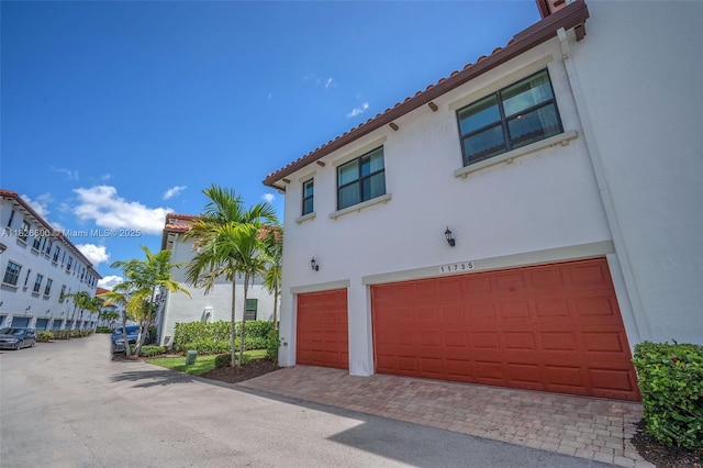 11735 SW 13th Ct, Pembroke Pines, FL 33025 - view of front facade featuring stucco siding, a garage, and a tile roof