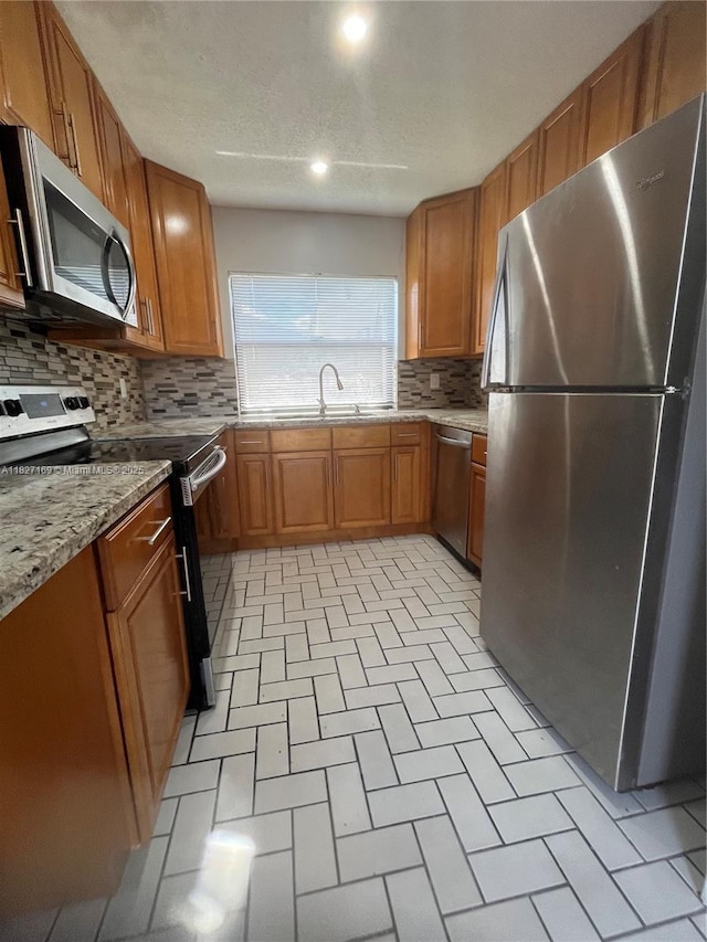 6298 NW 170th Ln, Hialeah, FL 33015 - kitchen with appliances with stainless steel finishes, decorative backsplash, brown cabinets, and recessed lighting
