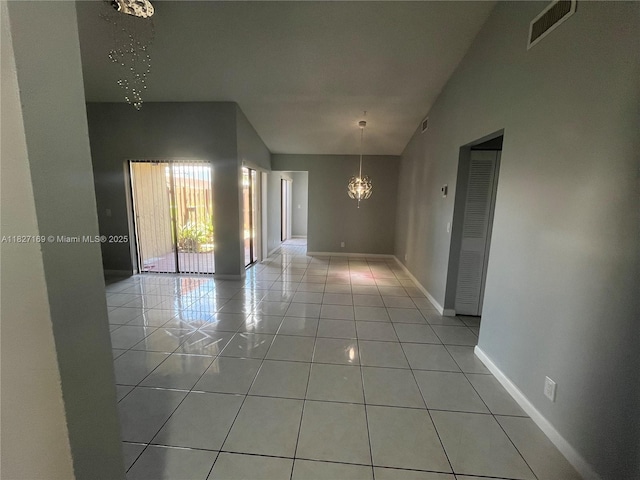 6298 NW 170th Ln, Hialeah, FL 33015 - spare room with a chandelier and light tile patterned floors