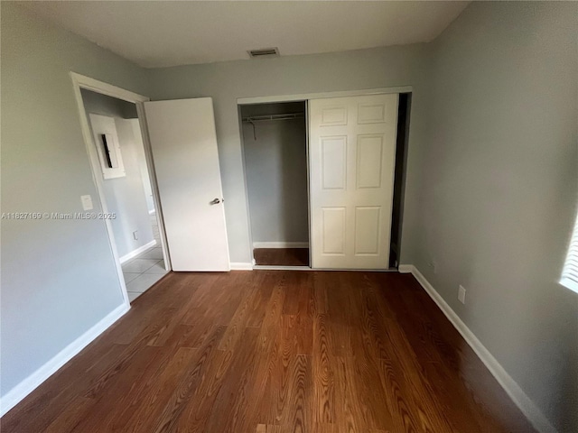 6298 NW 170th Ln, Hialeah, FL 33015 - unfurnished bedroom featuring a closet and wood finished floors