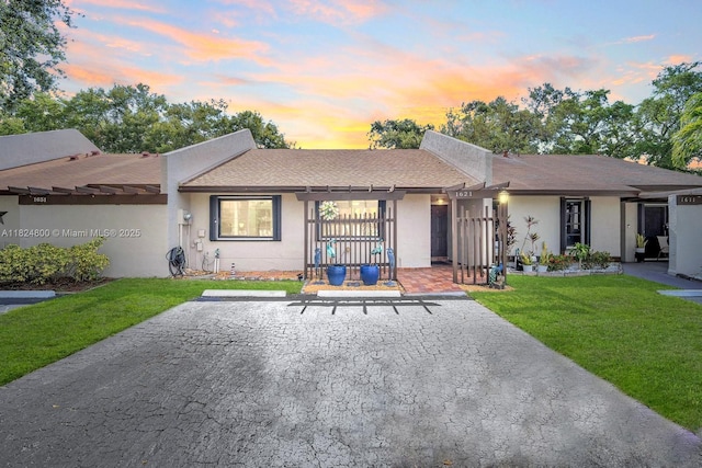 1621 NW 96th Ter, Pembroke Pines, FL 33024 - view of front facade featuring a front lawn, stucco siding, a shingled roof, and uncovered parking
