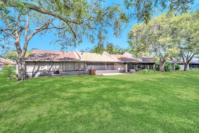 1621 NW 96th Ter, Pembroke Pines, FL 33024 - rear view of property featuring a sunroom and a lawn