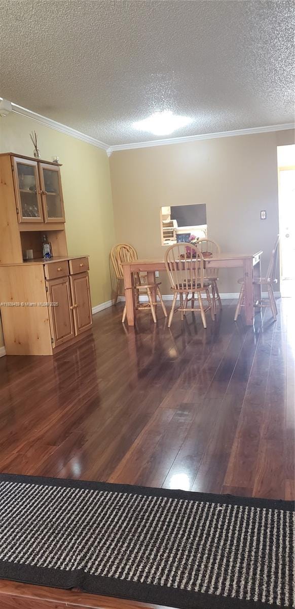 8280 Sunrise Lakes Blvd Unit 105, Sunrise, FL 33322 - dining area with ornamental molding, hardwood / wood-style flooring, and a textured ceiling