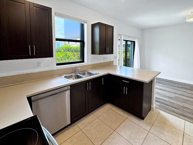 6011 W Paso Fino Pl, Davie, FL 33314 - kitchen featuring stainless steel dishwasher, light countertops, a peninsula, dark brown cabinets, and light tile patterned flooring