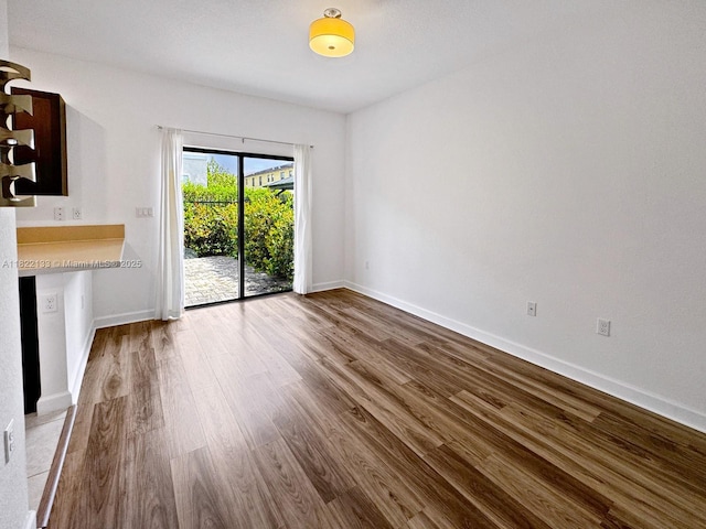 6011 W Paso Fino Pl, Davie, FL 33314 - unfurnished living room featuring wood finished floors and baseboards